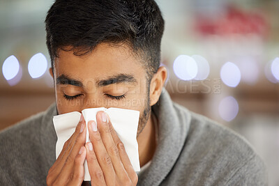 Buy stock photo Shot of a young man blowing his nose