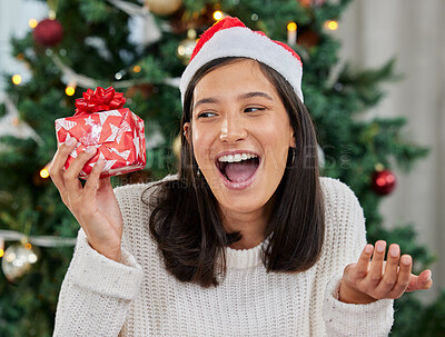 Buy stock photo Woman, Christmas and gift box or excited surprise for present or giveaway, package or prize. Female person, happiness and hat in home living room with festive season giving, December or celebration