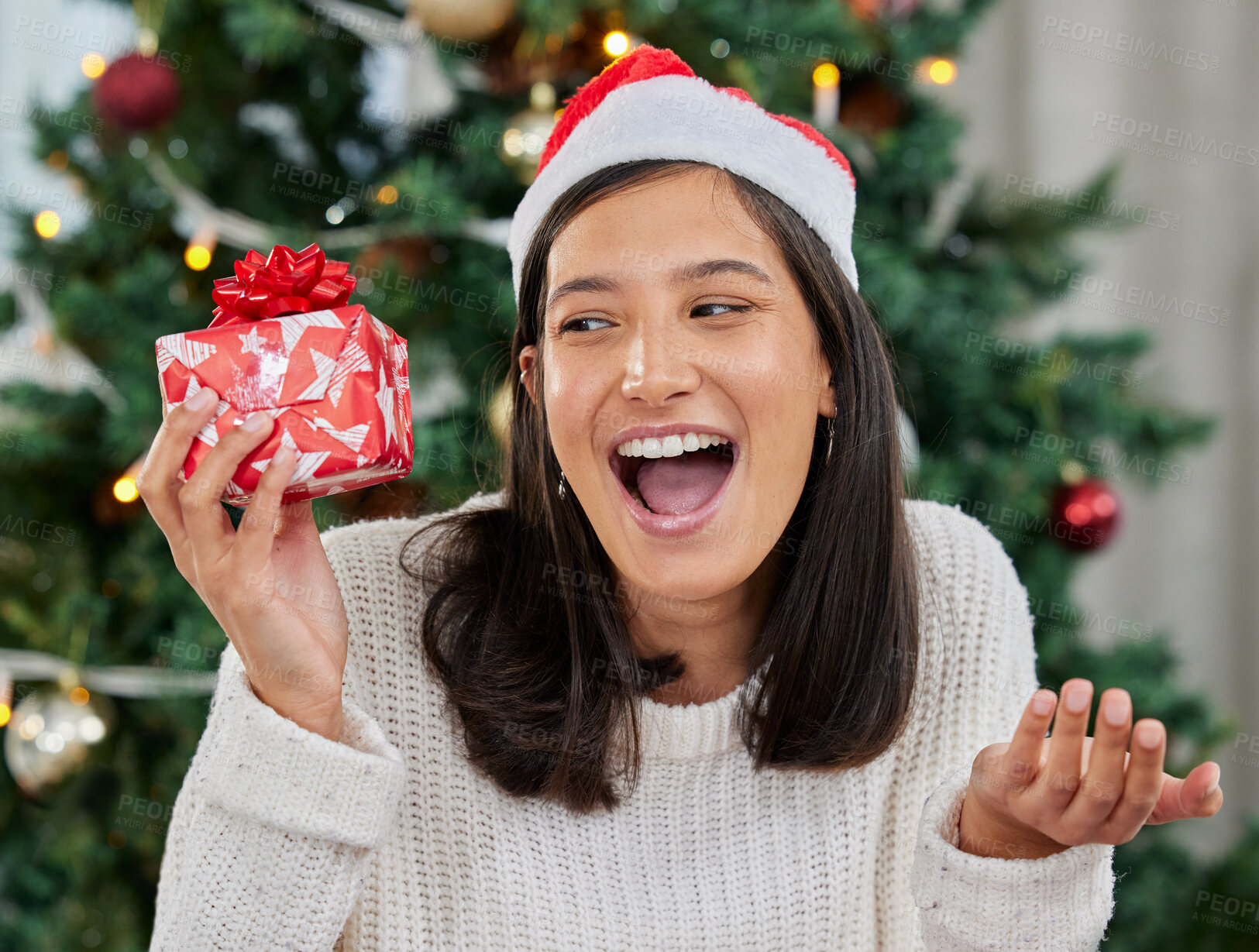 Buy stock photo Woman, Christmas and gift box or excited surprise for present or giveaway, package or prize. Female person, happiness and hat in home living room with festive season giving, December or celebration