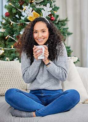 Buy stock photo Shot of a young woman drinking coffee during Christmas time at home