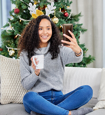 Buy stock photo Woman, selfie and Christmas holiday in home with coffee drink as social media post, tree or connection. Female person, cellphone and smile on couch in apartment or festive season, decorations or xmas