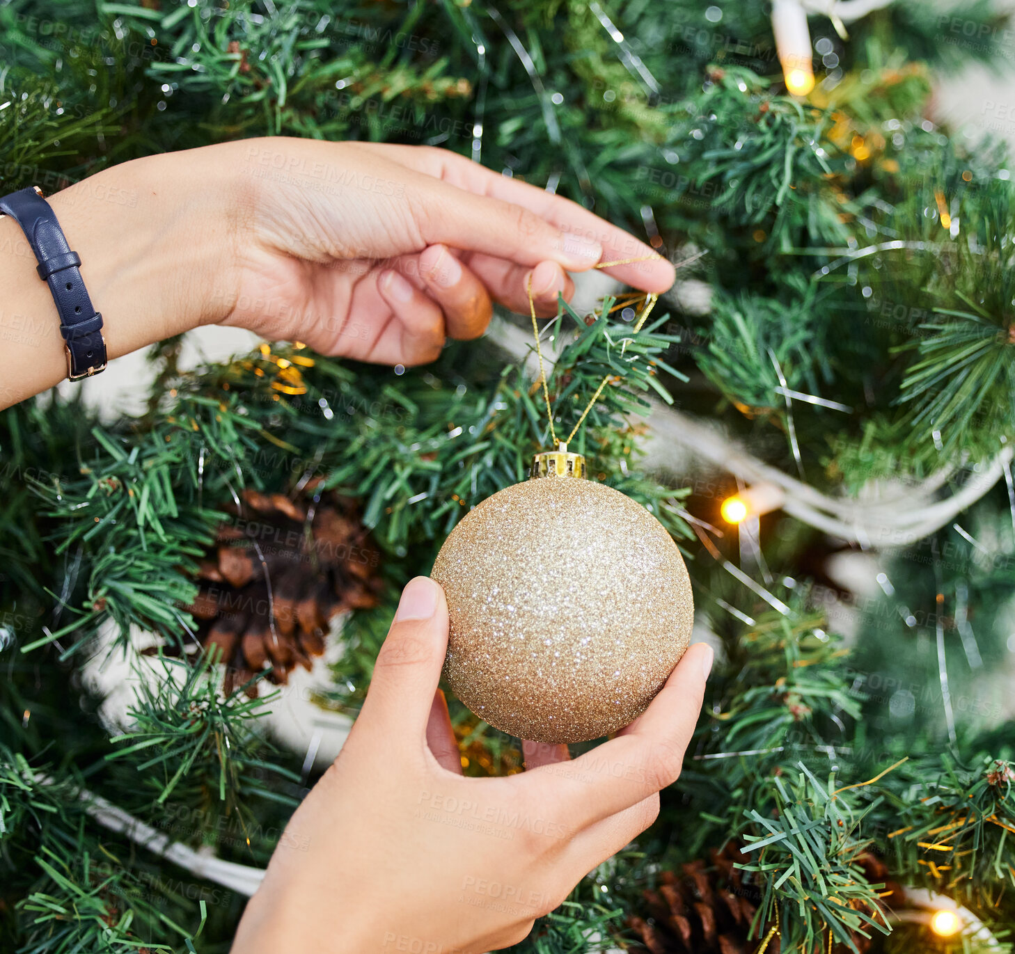 Buy stock photo Person, hands and bauble with Christmas tree for decoration, festive or holiday season at home. Closeup of ornament, lights and decor with glitter ball in December celebration or new year preparation