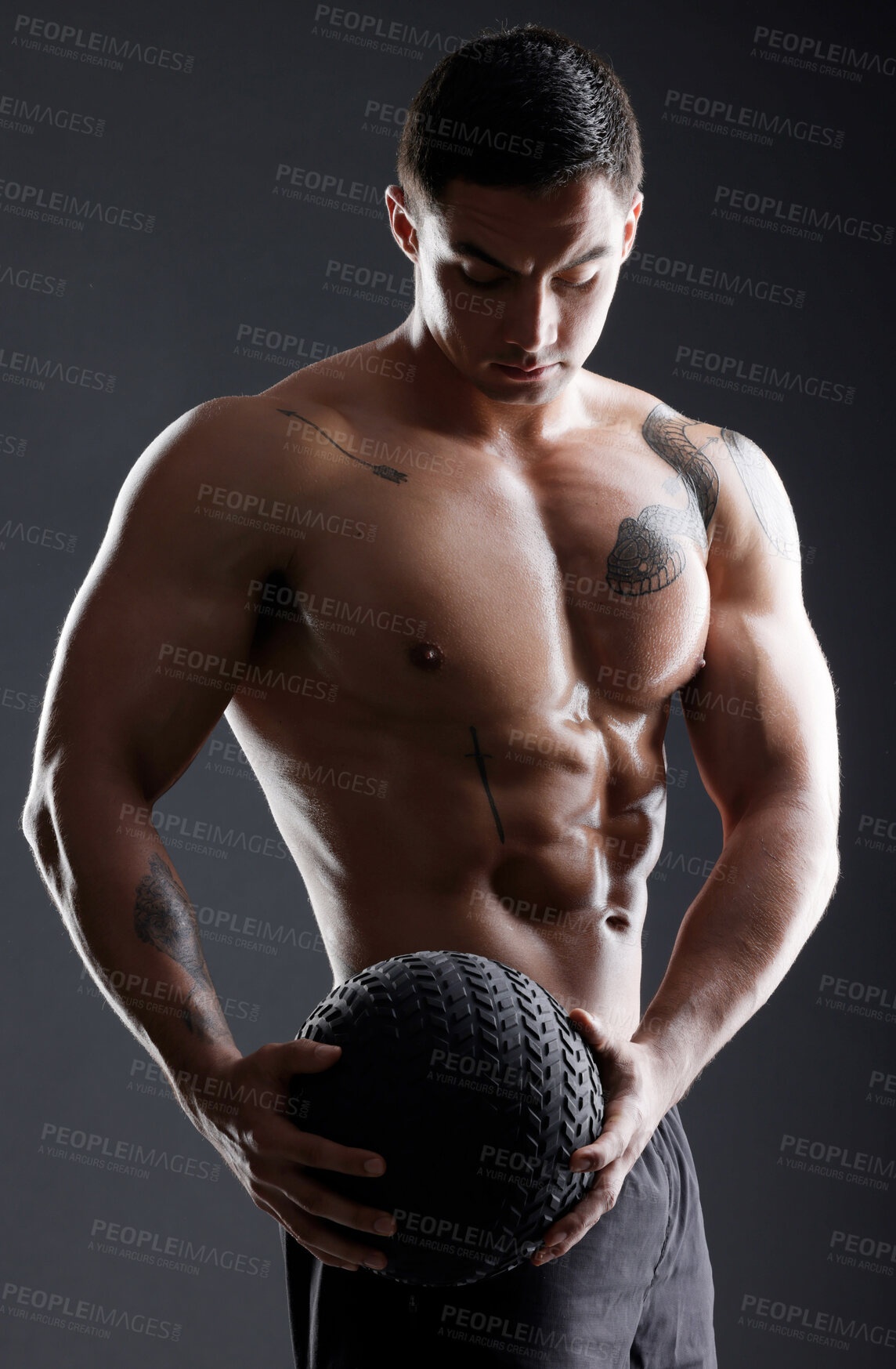 Buy stock photo Ball, bodybuilder or strong man in studio for workout, training or exercise for power or strength. Black background, fitness or topless athlete with equipment for arms, sports challenge or wellness