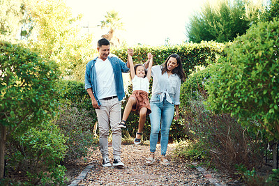 Buy stock photo Shot of a family taking a walk through their garden together