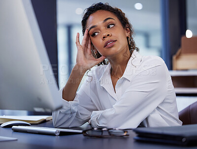 Buy stock photo Shot of a young businesswoman looking stressed while sitting at a desk at work