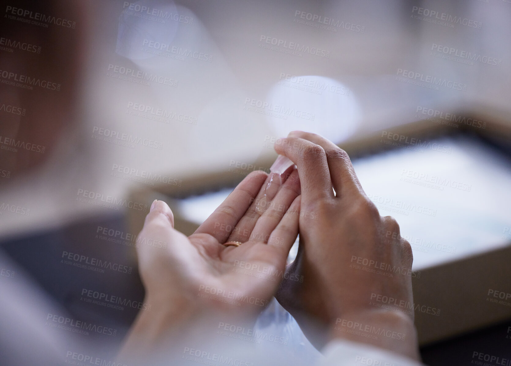 Buy stock photo Shot of an unrecognizable businessperson sanitising their hands at work