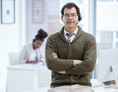 Buy stock photo Portrait of a young businessman wearing a headset while working in an office