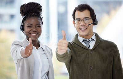 Buy stock photo Portrait of two call centre agents showing thumbs up in an office
