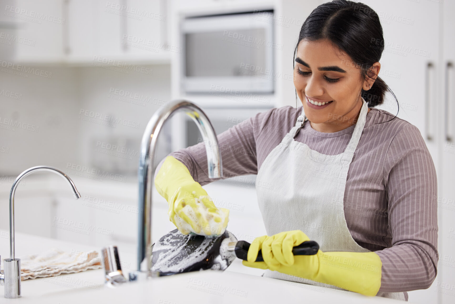 Buy stock photo Smile, woman and washing dishes in home for cleaning, hygiene and routine housework in kitchen. Happy, soap and sponge on pan with foam for dirt, safety and maid with chores for housekeeping service