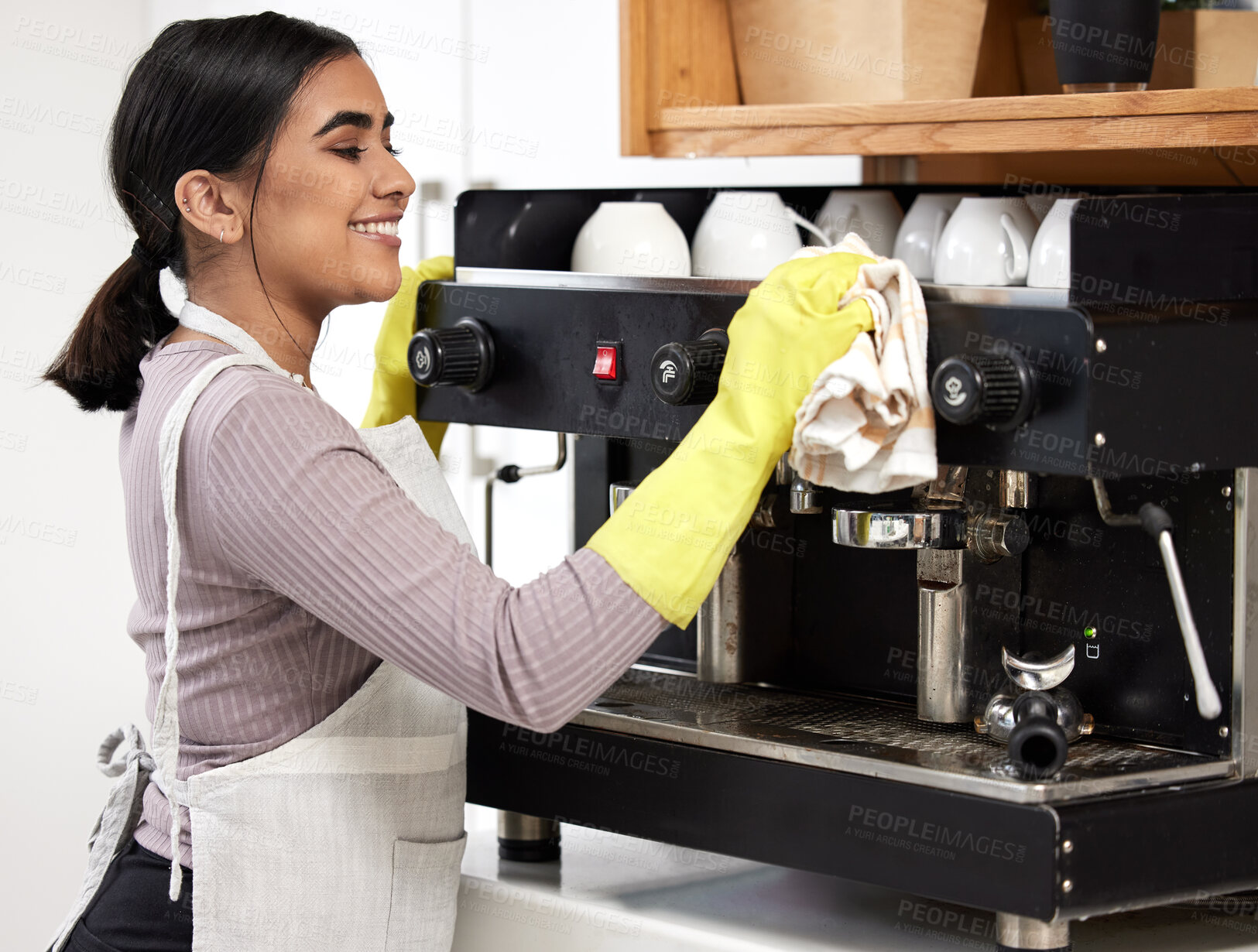 Buy stock photo Barista, smile and wipe coffee machine in coffee shop, deli and cafe for sanitation, cleansing and dusting. Happy, woman and polish espresso maker in diner, bakery and restaurant for routine clean