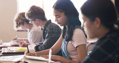 Buy stock photo High school, students and group at desk in classroom for learning education, academic or scholarship. Boy, girl and books at academy campus for future development or lesson, assessment or friends