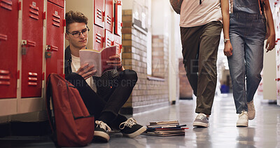 Buy stock photo Young, student or boy and reading book in school on floor for knowledge, information and education. Male person or teenager and studying with glasses and textbook learning for exam or test on break
