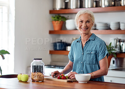 Buy stock photo Portrait of a mature woman preparing a healthy breakfast in the kitchen at home
