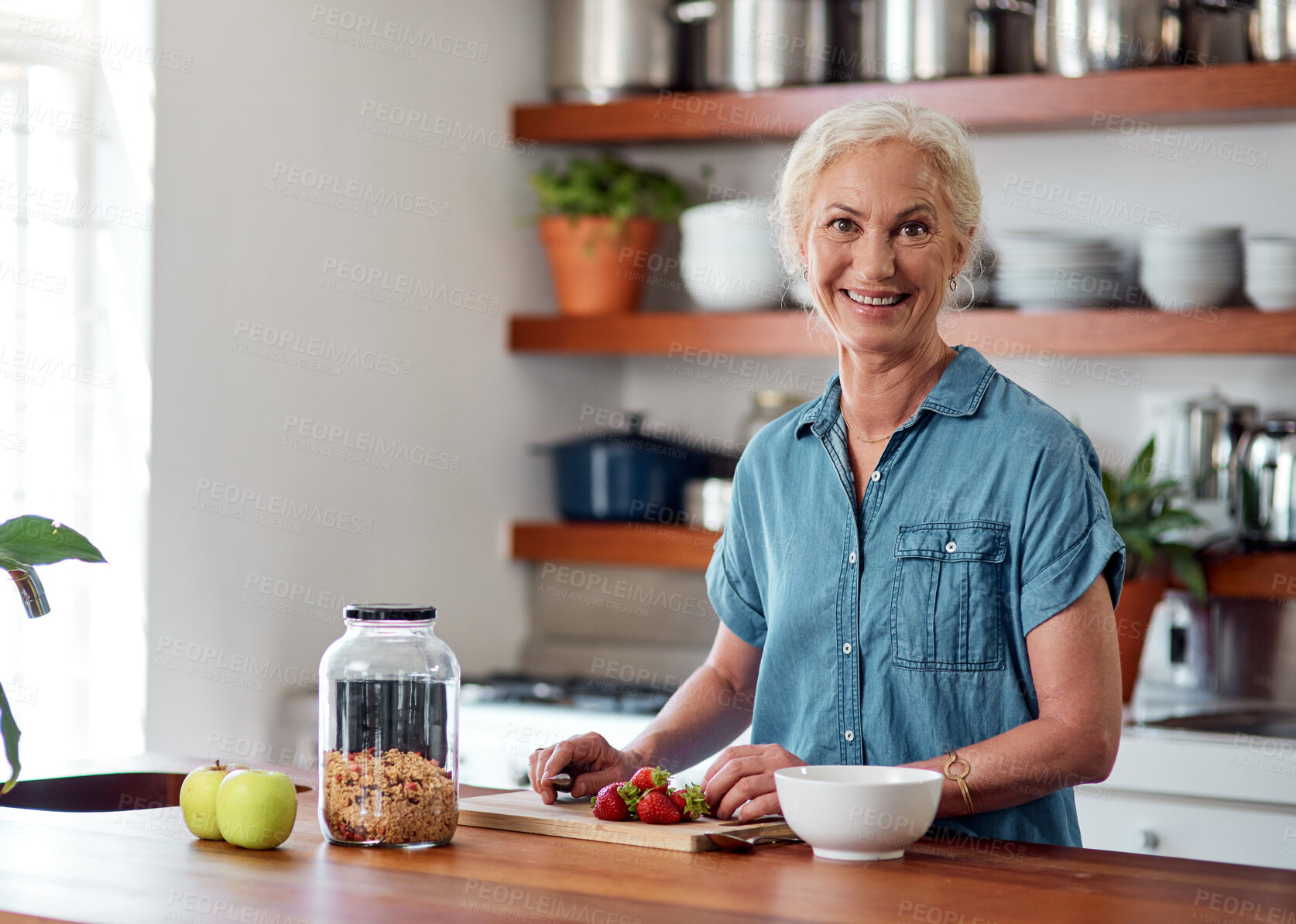 Buy stock photo Senior woman, portrait or kitchen with strawberries for breakfast or health, vegan diet or nutrition for wellness. Female person, home or cutting board with fruit salad for retirement, food or muesli