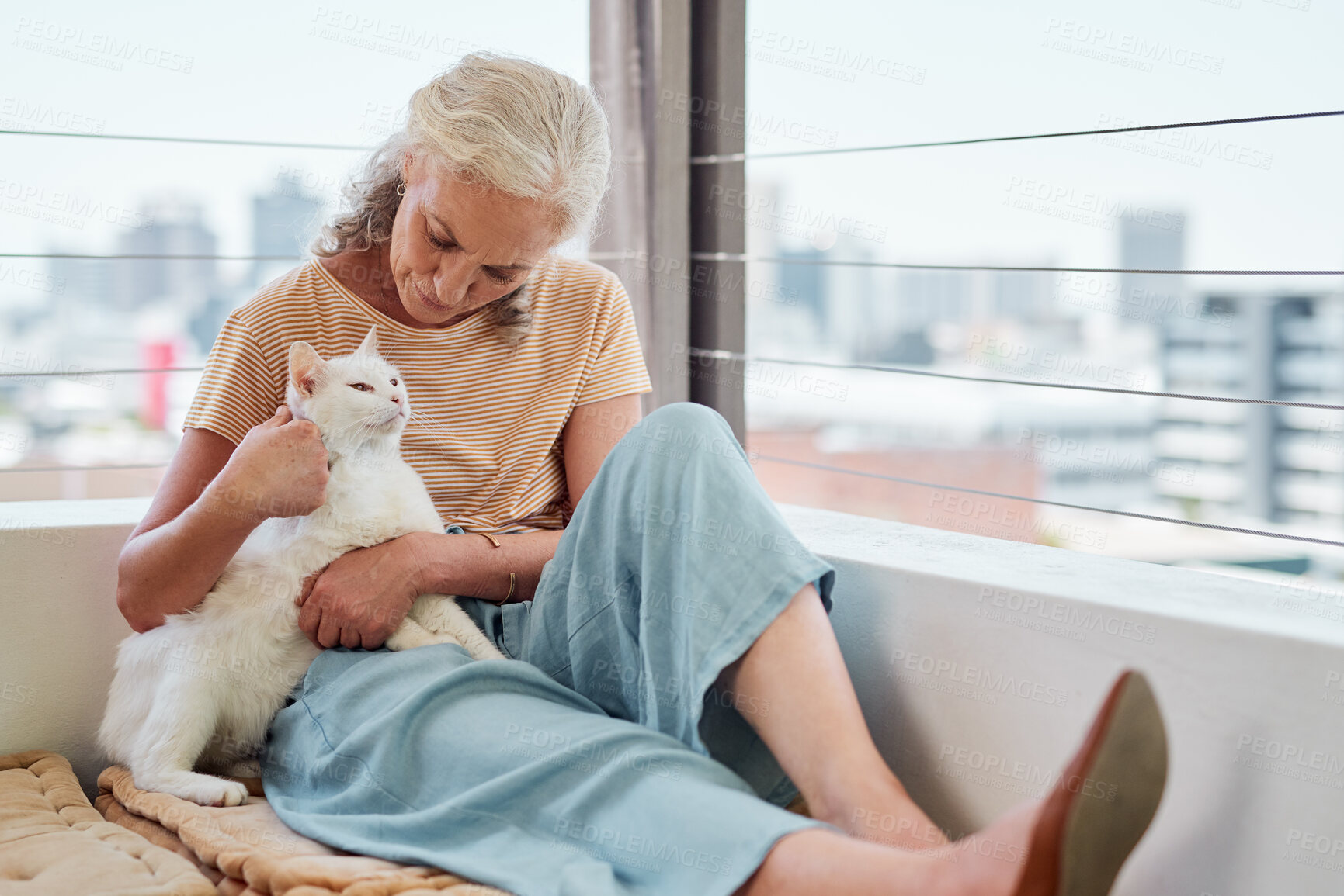 Buy stock photo Senior woman, outdoor and relax with cat for calm weekend, bonding time and emotional support in home. Elderly person, animal and pet kitten with retirement, mental health and love cuddle on balcony