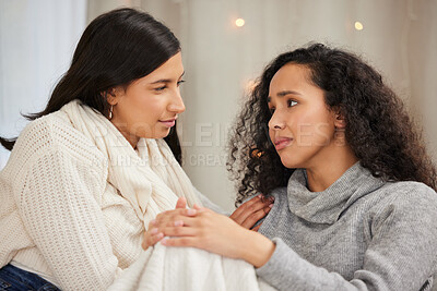 Buy stock photo Shot of two friends looking sad while talking at home