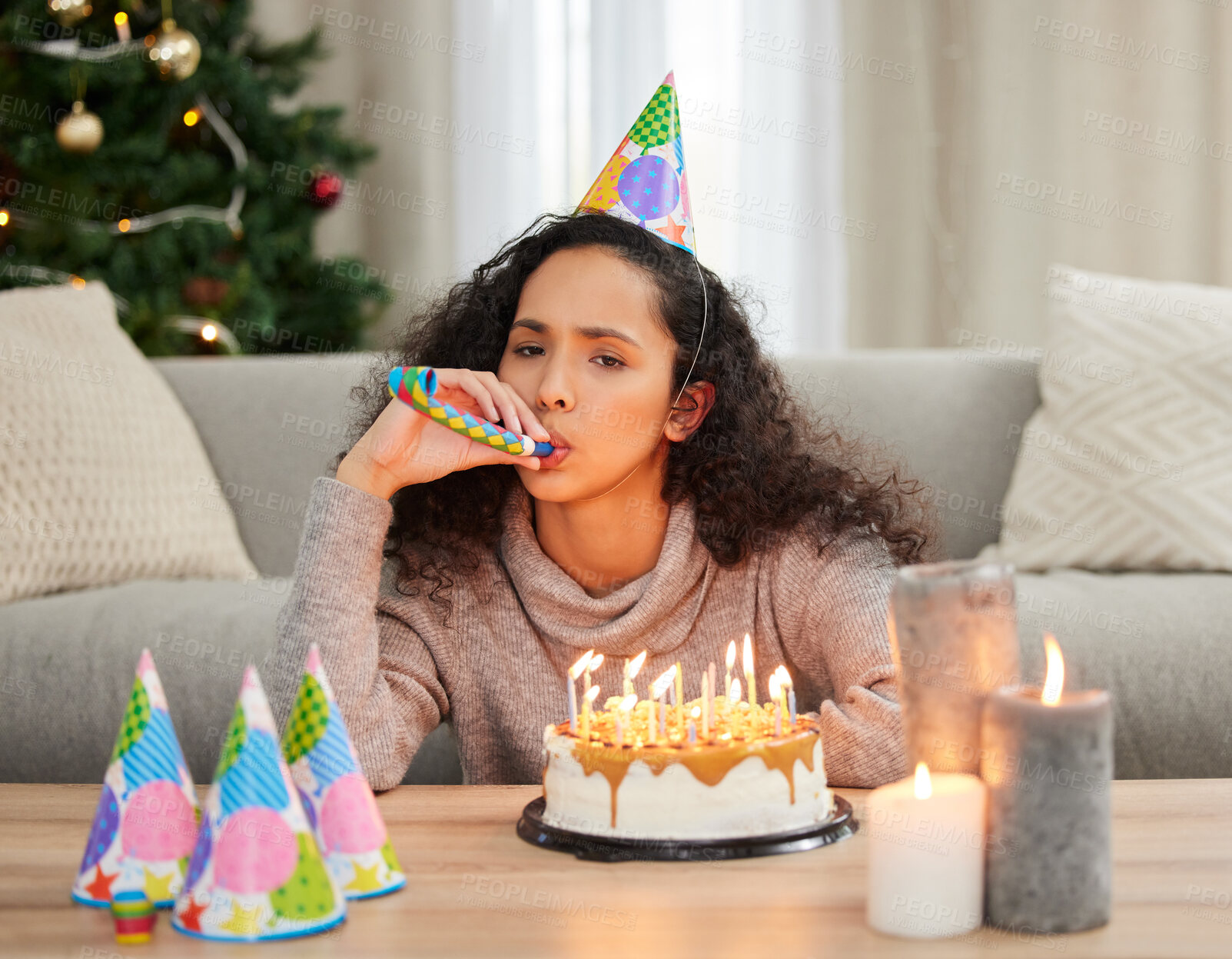 Buy stock photo Woman, celebrate and unhappy birthday in home, sad and grief for turning older with cake and candles in festive season. Depressed, loneliness and decorations for holiday blues, party hat and upset