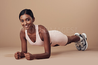 Buy stock photo Full length shot of an attractive young woman working out in the studio and holding a plank position