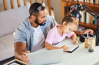 Buy stock photo Shot of a young father showing his daughter his work while she uses his digital tablet