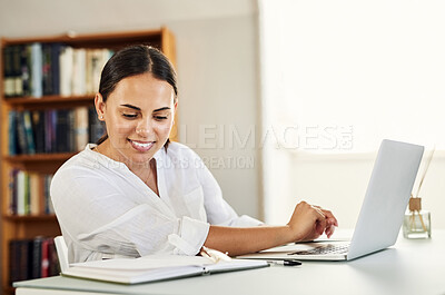 Buy stock photo Shot of a young businesswoman reading her notes while working from home