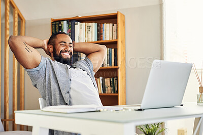 Buy stock photo Shot of a young businessman taking a break from working at home