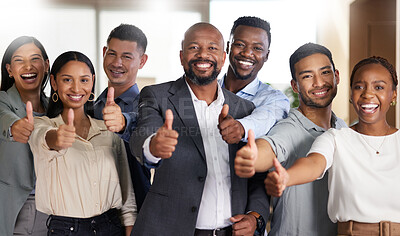 Buy stock photo Cropped portrait of a diverse group of businesspeople gesturing thumbs up while standing in their office