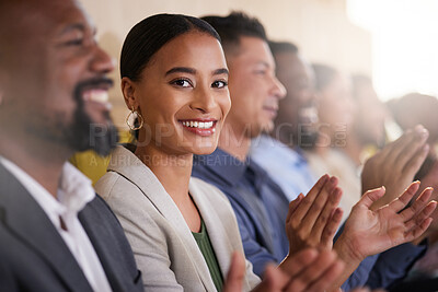 Buy stock photo Cropped portrait of an attractive young businesswoman applauding while sitting with her colleagues in the boardroom during a presentation