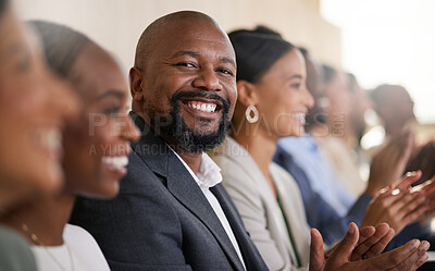 Buy stock photo Cropped portrait of a handsome mature businessman applauding while sitting with his colleagues in the boardroom during a presentation