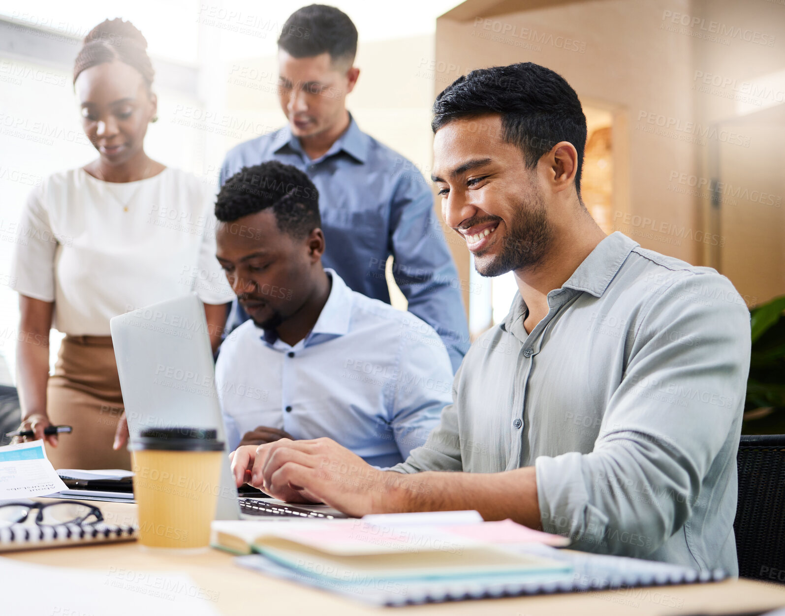 Buy stock photo Cropped shot of a handsome young businessman sitting with his colleagues in the boardroom during a meeting