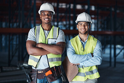 Buy stock photo Shot of two young contractors standing together in the warehouse with their arms crossed