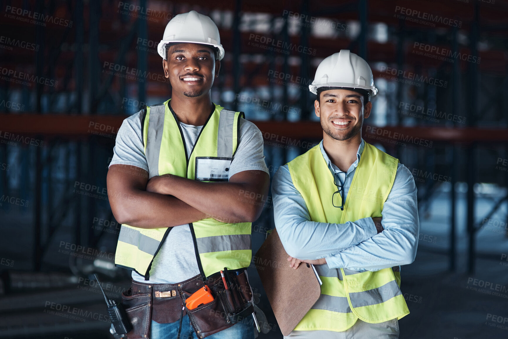 Buy stock photo Shot of two young contractors standing together in the warehouse with their arms crossed