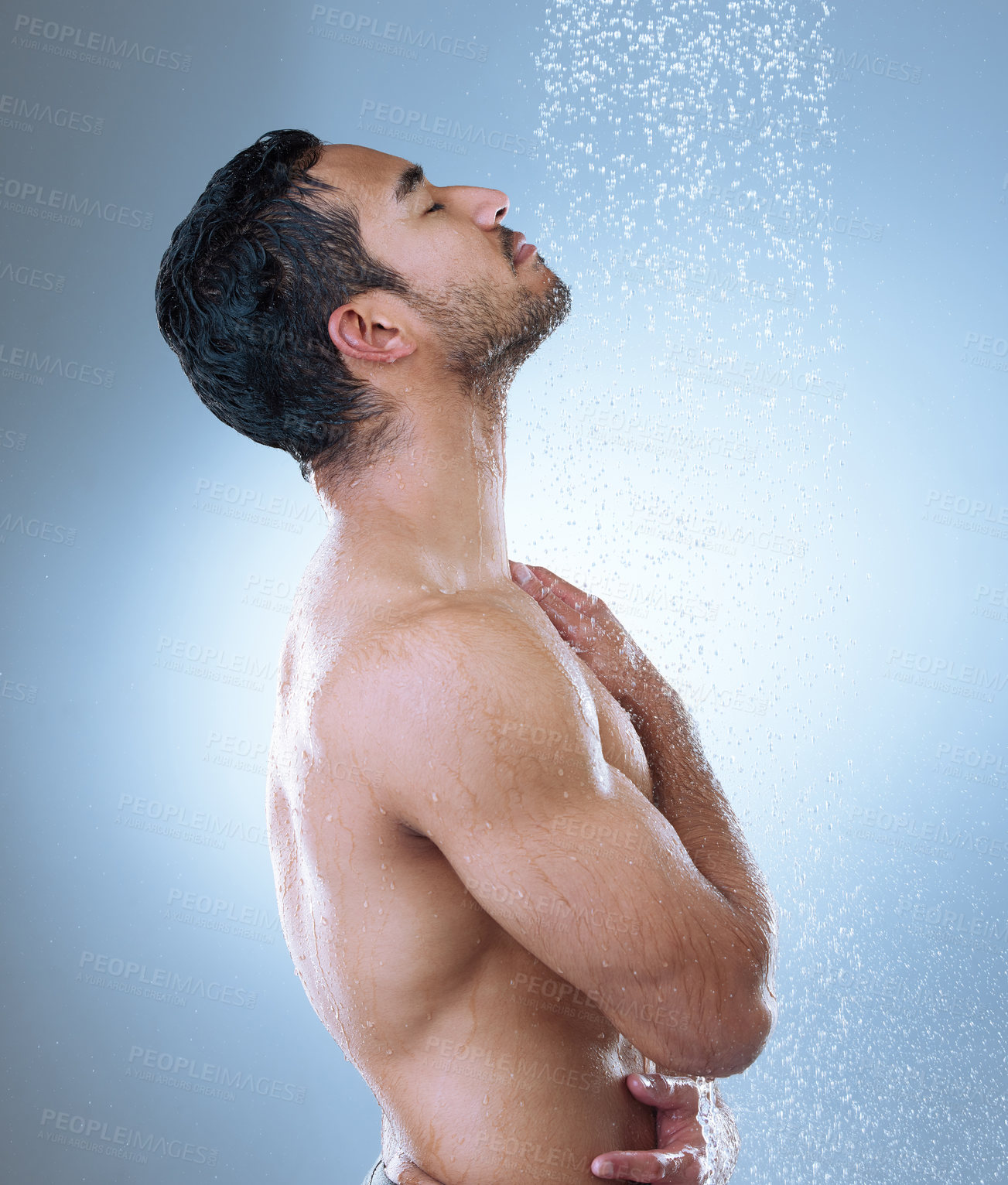 Buy stock photo Studio shot of a handsome young man washing his hair in a shower against a grey background