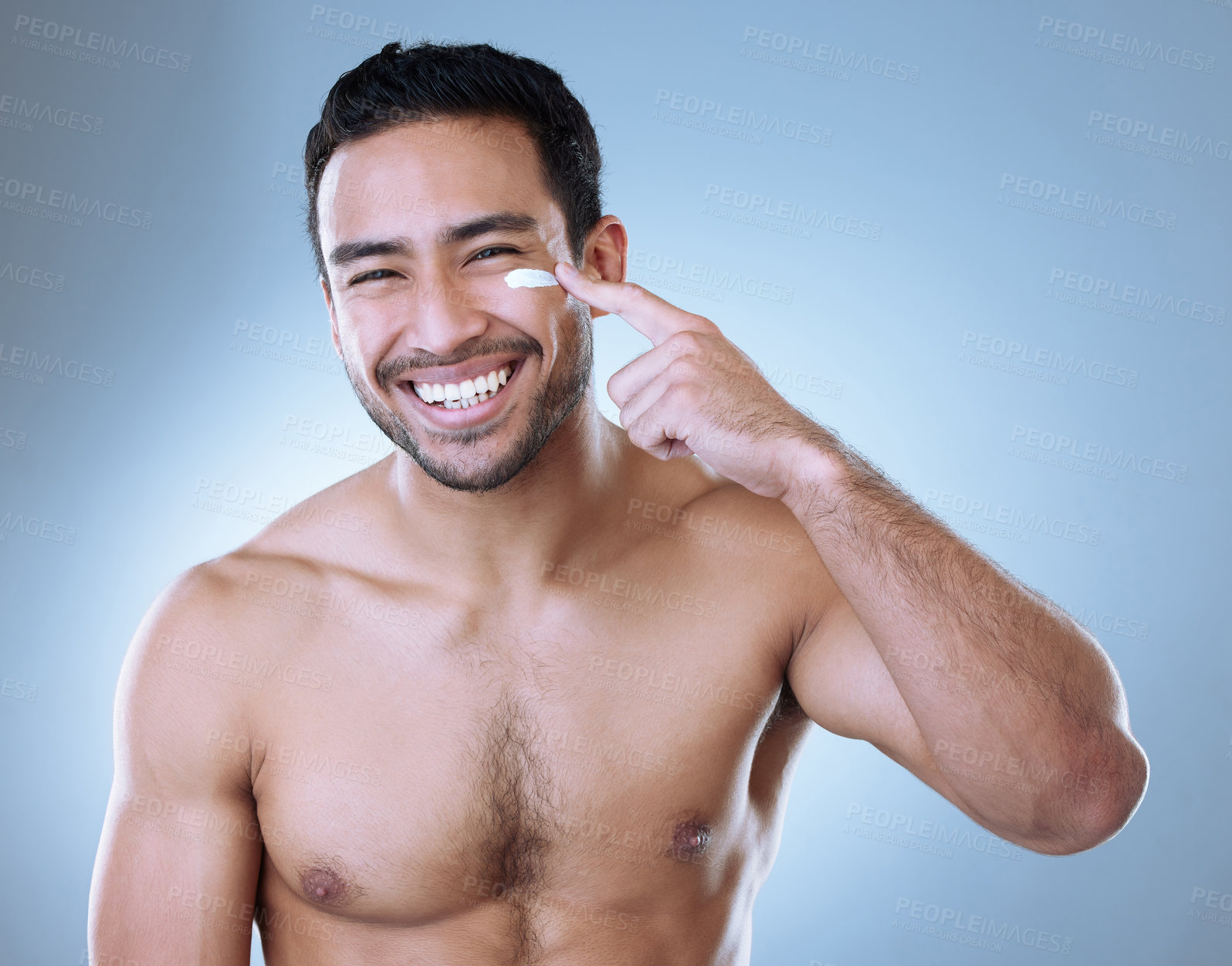 Buy stock photo Man, excited and face cream with dermatology for hygiene, skincare and grooming in blue background. Male person, clean and healthy for wellness, confidence and cosmetic with happy in studio backdrop