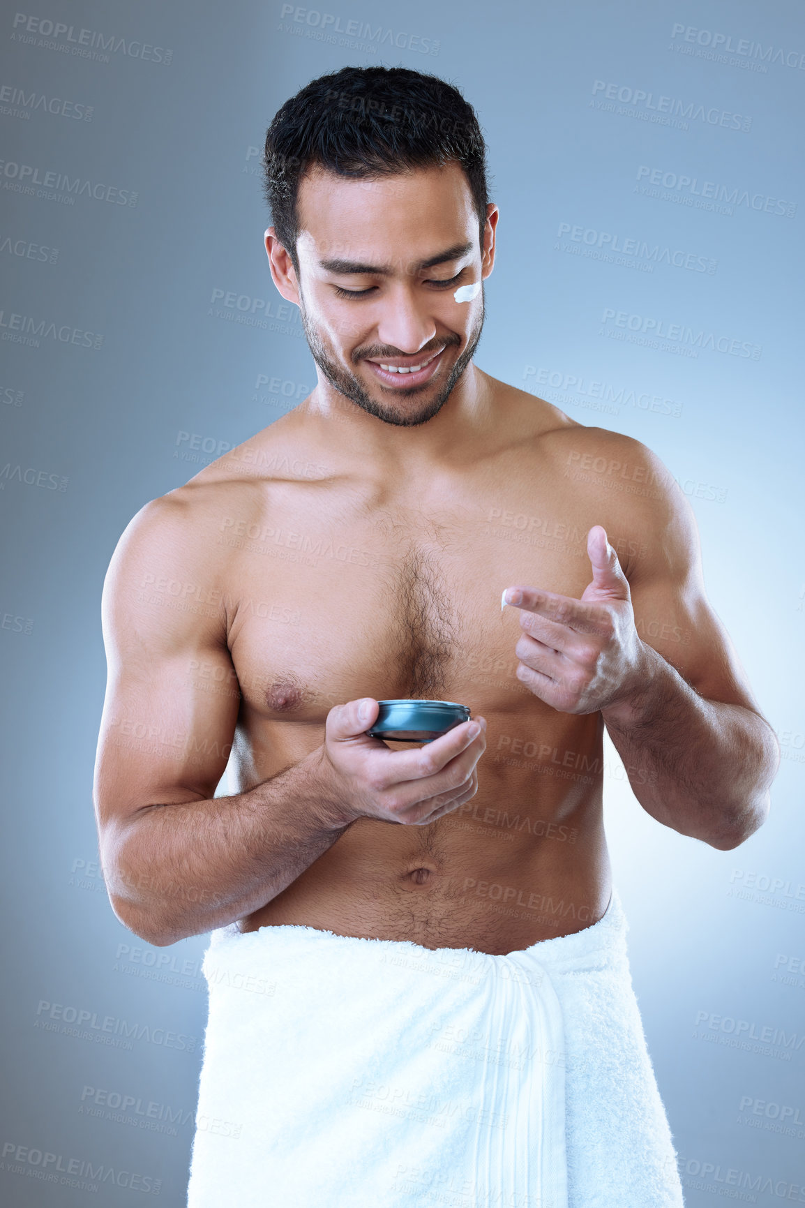Buy stock photo Beauty cream, skincare and man in studio with towel for moisturizer, cosmetics or morning routine on gray background. Luxury, grooming and Asian model with product for lotion, sunscreen or body care