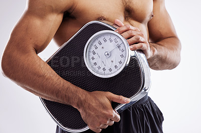 Buy stock photo Man, muscle and fitness holding scale in studio white background for workout, exercise and weight loss. Male person, wellness and health progress check for training, self care and bodybuilding