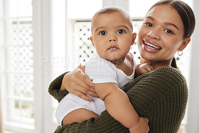 Buy stock photo Shot of a young mother holding her baby
