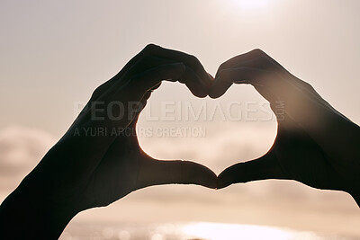 Buy stock photo Silhouette, heart hands and couple at beach for sunset, love and bonding for care together on summer holiday. Shadow, closeup and romance at ocean sea for peace, support and emoji sign for connection