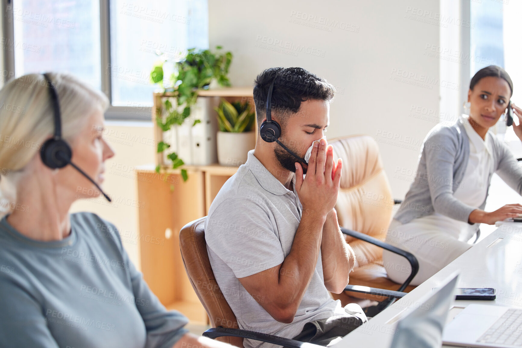 Buy stock photo Man, sick and coworkers in call centre office or blowing nose with unhappy colleagues, telemarketing or flu. Male person, headset and customer service or with cold symptoms, contagious or illness