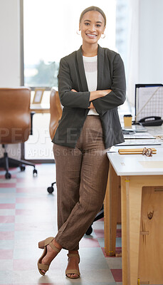 Buy stock photo Portrait of a confident young businesswoman standing with her arms crossed in an office