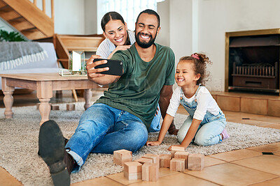 Buy stock photo Shot of a happy family taking selfies together at home