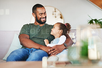 Buy stock photo Shot of a father and his little daughter relaxing together at home