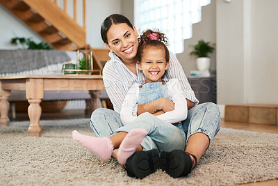 Buy stock photo Portrait of a mother and her little daughter relaxing together at home