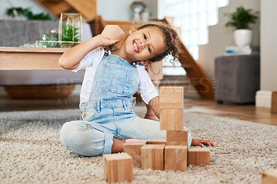 Buy stock photo Portrait of an adorable little girl playing with wooden blocks at home