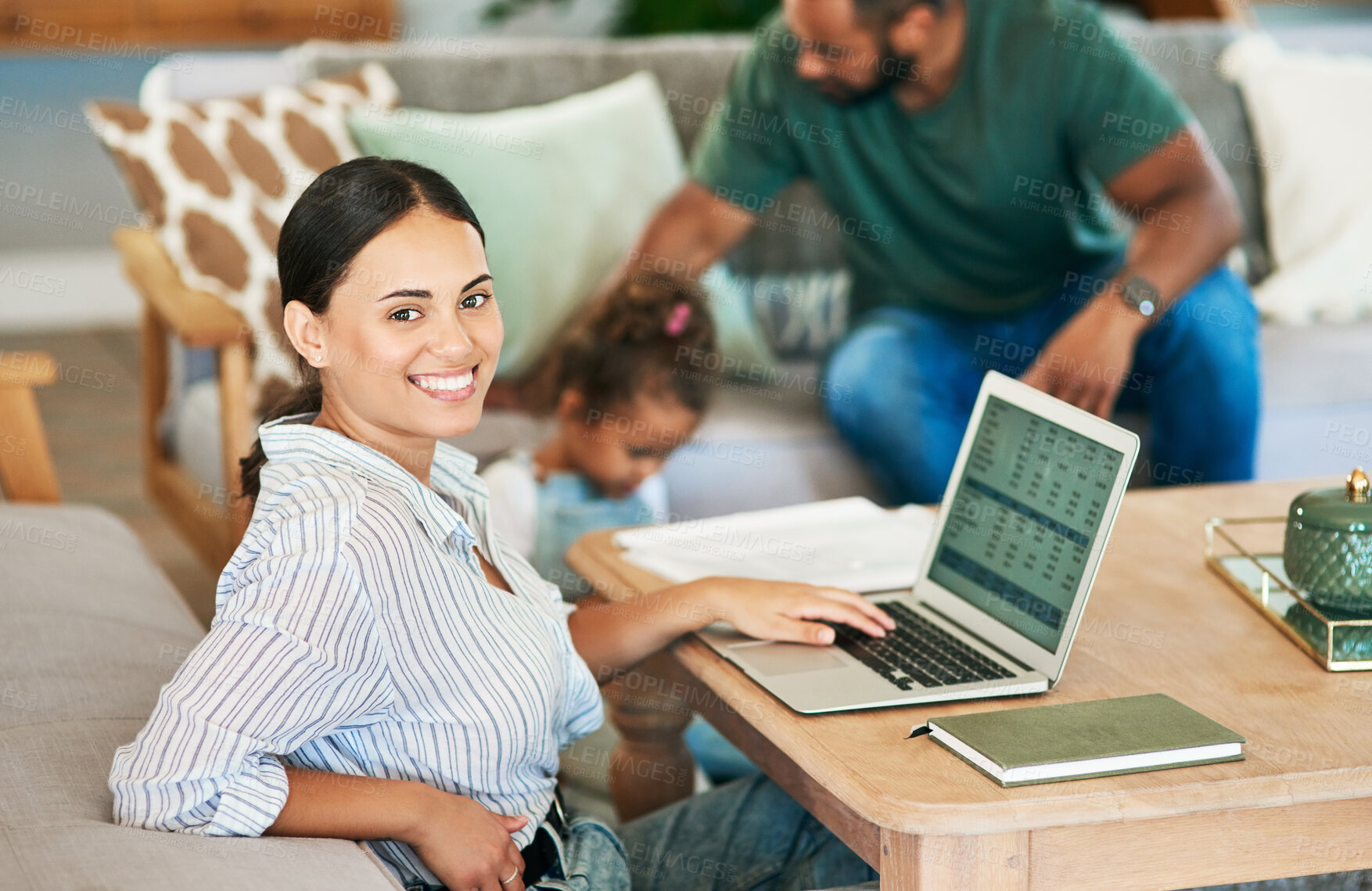 Buy stock photo Portrait of a mother using a laptop while her husband takes care of their little daughter at home