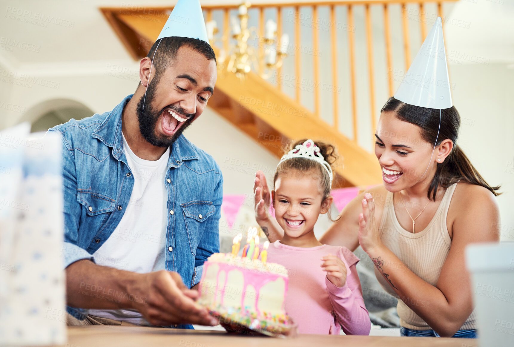 Buy stock photo Shot of a little girl celebrating a birthday with her parents at home