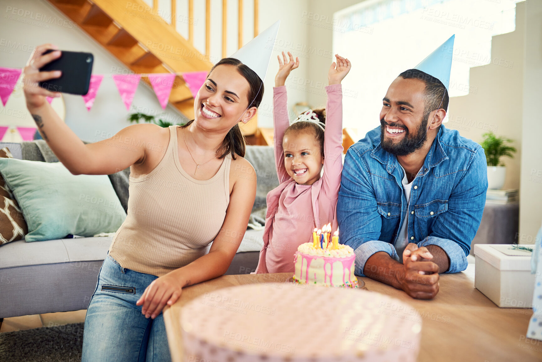 Buy stock photo Shot of a young mother taking a selfie at her daughter's birthday celebration at home