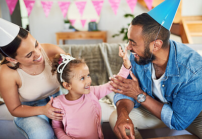 Buy stock photo Shot of a little girl celebrating a birthday with her parents at home