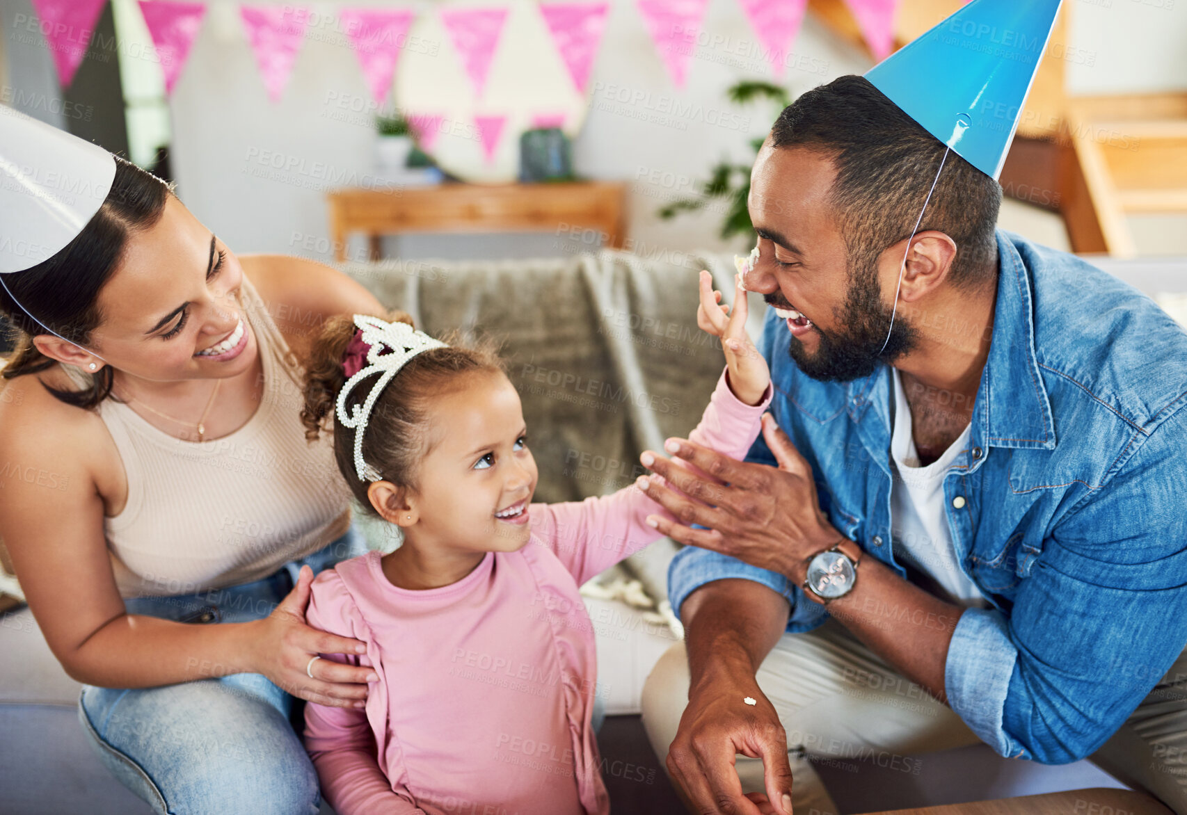 Buy stock photo Shot of a little girl celebrating a birthday with her parents at home