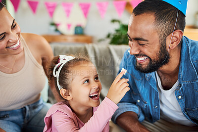 Buy stock photo Shot of a little girl celebrating a birthday with her parents at home