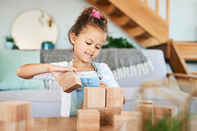 Buy stock photo Portrait of an adorable little girl playing with wooden blocks at home